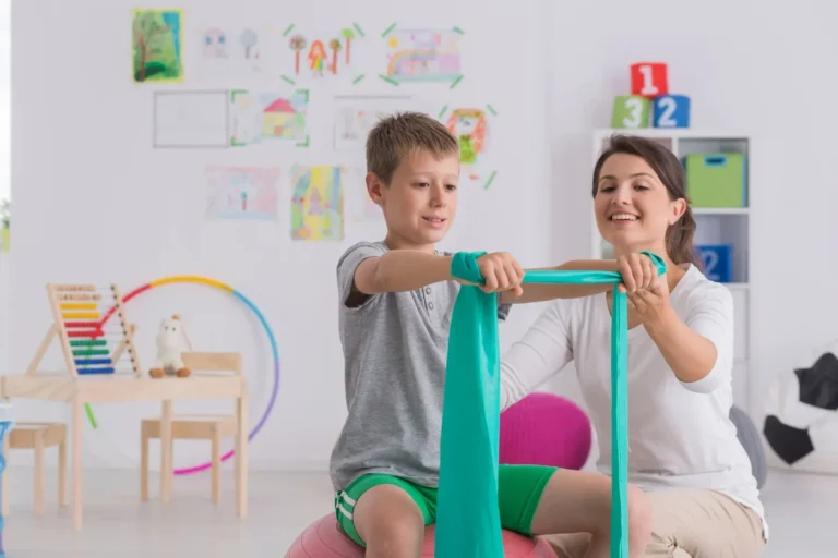 Paediatric Exercise Physiologist guiding children through exercises at Iconic Care Group in Australia